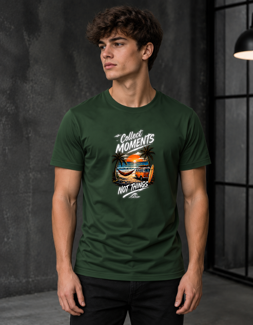 A man wearing a Bottle green crewneck t-shirt with a graphic print that reads 'Collect Moments NOT Things' around a beach scene, set against a dark gray textured studio background.