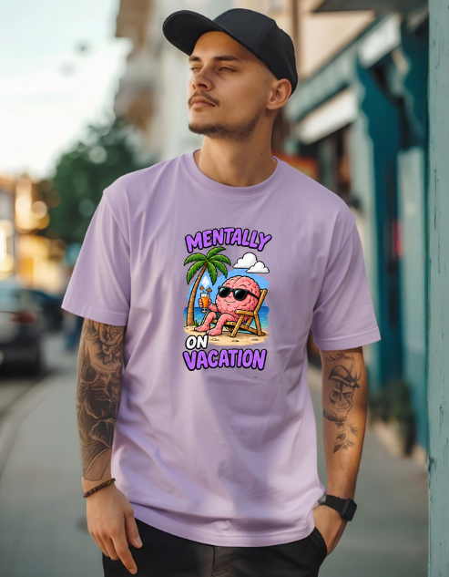A man wearing a light purple graphic t-shirt with a cartoon brain relaxing on a beach chair under the text 'MENTALLY ON VACATION'. He is also wearing a black baseball cap and standing on a blurred outdoor street background.