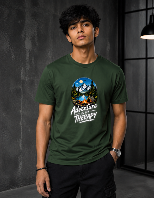 A man wearing a Bottle Green crewneck t-shirt with a circular graphic of a mountain campsite and the text 'Adventure is Therapy'.