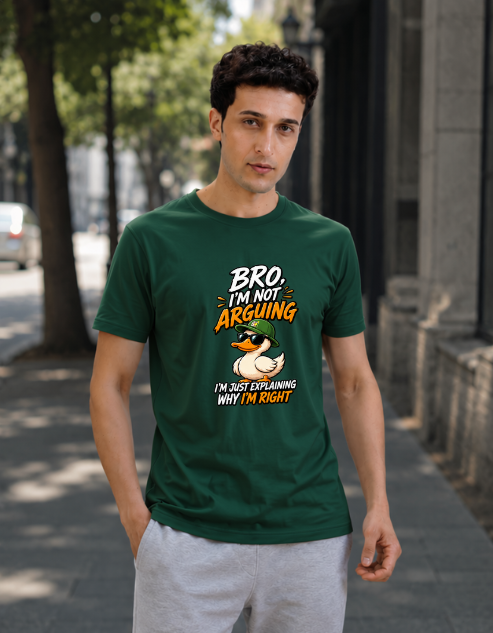 A man wearing a Bottle green graphic t-shirt with a duck illustration and the text 'BRO I'M NOT ARGUING I'M JUST EXPLAINING WHY I'M RIGHT', standing on a city sidewalk.
