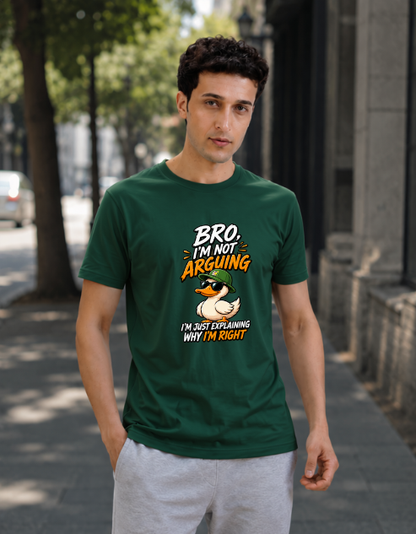 A man wearing a Bottle green graphic t-shirt with a duck illustration and the text 'BRO I'M NOT ARGUING I'M JUST EXPLAINING WHY I'M RIGHT', standing on a city sidewalk.
