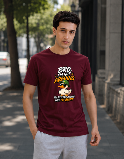 A man wearing a maroon graphic t-shirt with a duck illustration and the text 'Bro I'm Not Arguing I'm Just Explaining Why I'm Right', paired with light gray sweatpants, standing on a city sidewalk.