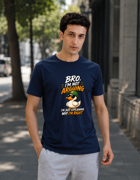 A man wearing a navy blue graphic t-shirt with a duck illustration and the text 'Bro I'm Not Arguing I'm Just Explaining Why I'm Right', standing on a city sidewalk.