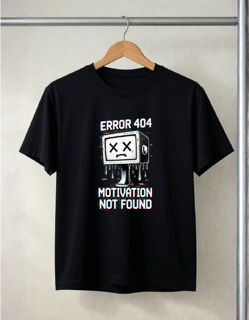 A black short-sleeve t-shirt hanging on a wooden hanger against a light beige wall. The shirt features a white and red graphic of a dripping TV with an X for a face, with the text 'ERROR 404' above and 'MOTIVATION NOT FOUND' below.