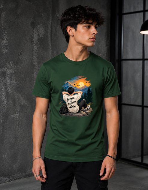 A man wearing a Bottle green crewneck t-shirt with a colorful graphic print of a person sitting in a forest at night under a full moon. The shirt features the text 'Escape to the woods' on the front graphic.