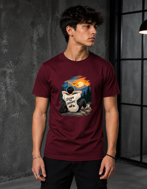 A man wearing a maroon crewneck t-shirt with a graphic print on the front, set against a dark gray textured wall.