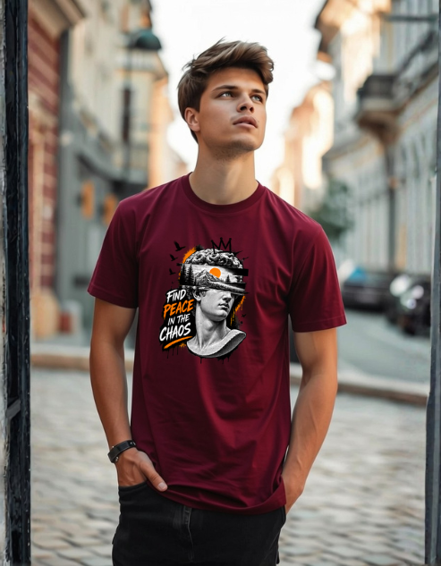 A man wearing a maroon graphic t-shirt with a print of Michelangelo's David and the text 'FIND PEACE IN THE CHAOS' in an outdoor street setting.
