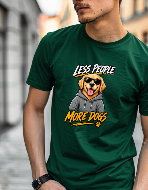 A man wearing a Bottle green graphic t-shirt with a cartoon dog wearing sunglasses and a hoodie, with the text 'LESS PEOPLE MORE DOGS' printed on the front, set against a blurred outdoor background.