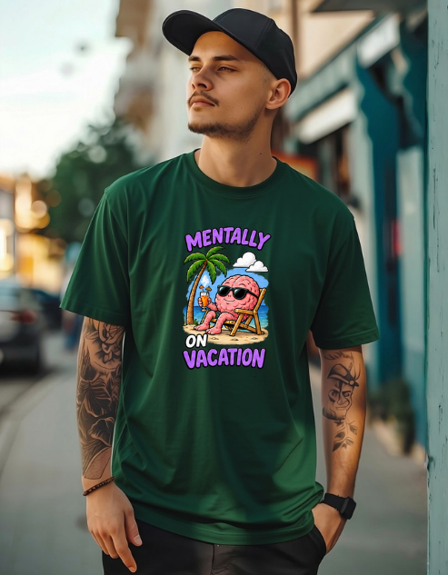 A man wearing a dark green graphic t-shirt with a cartoon brain on a beach chair and the text 'MENTALLY ON VACATION' in purple, standing on a blurred street background.