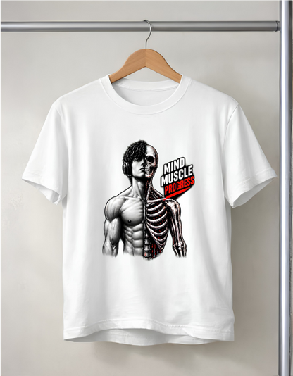 A white short-sleeve crewneck t-shirt hanging on a wooden hanger from a metal clothing rack. The shirt features a graphic print of a muscular male torso with the left side of the chest removed to reveal a skeleton, alongside the text 'MIND MUSCLE PROGRESS' in white and red.