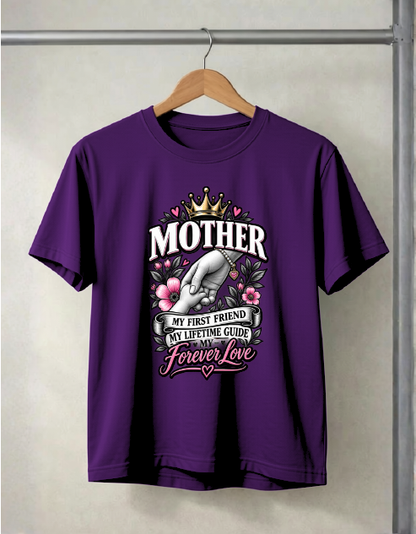 A purple short-sleeve graphic t-shirt hanging on a wooden hanger against a light gray wall. The graphic features a hand holding a crown, pink flowers, and the text 'MOTHER MY FIRST FRIEND MY LIFETIME GUIDE AND MY FOREVER Love'.