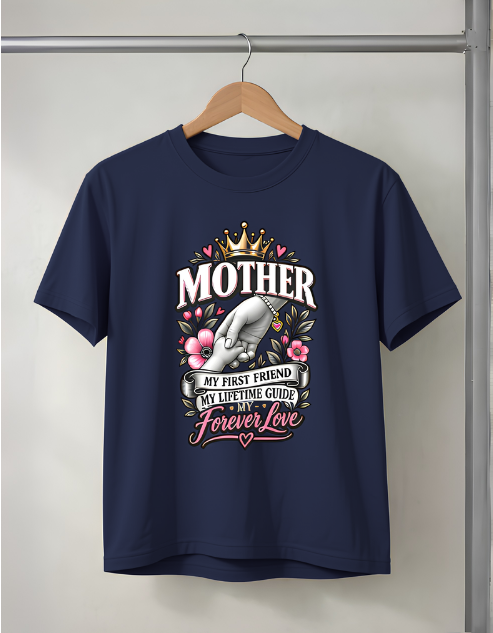 A navy blue short-sleeve t-shirt hanging on a wooden hanger against a light gray wall. The shirt features a large graphic print on the front with the word 'MOTHER' in white, a gold crown, pink flowers, a gray hand holding a phone, and the phrases 'MY FIRST FRIEND', 'MY LIFETIME GUIDE', and 'Forever Love'.