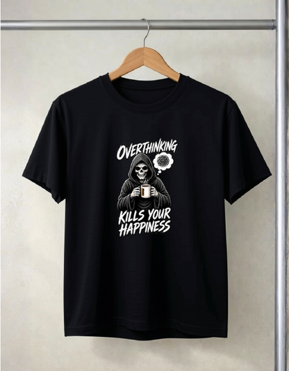 A Black short-sleeve t-shirt hanging on a wooden hanger against a light gray textured wall. The shirt features a white graphic print of a skeleton in a hoodie holding a mug, with the text 'OVERTHINKING KILLS YOUR HAPPINESS' and a small flower illustration.