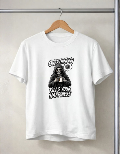 A white short-sleeve crewneck t-shirt hanging on a wooden hanger against a light beige wall. The shirt features a black graphic of a skeleton in a hood holding a mug, with the text 'OVERTHINKING KILLS YOUR HAPPINESS' and a small clock graphic.